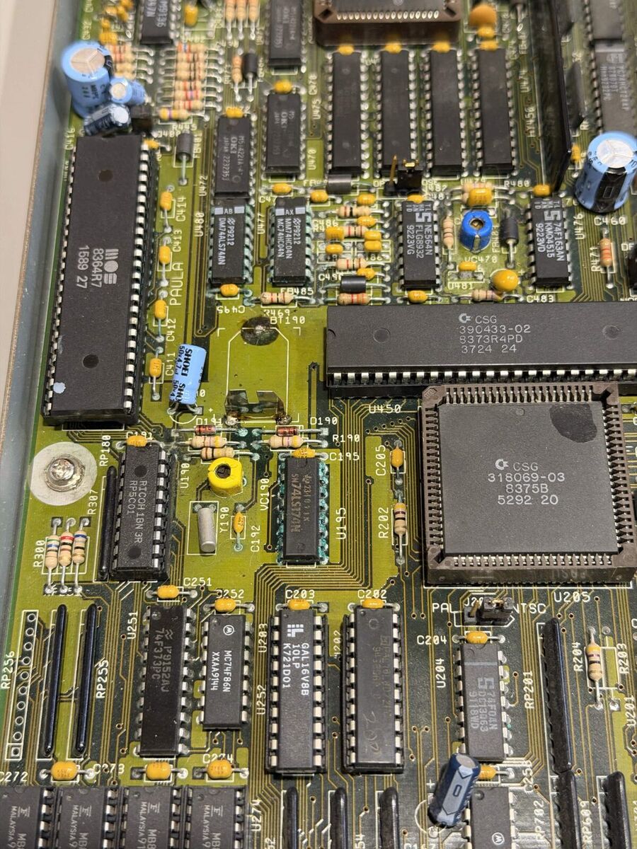 Amiga 3000 motherboard before repair, with green corrosion around the clock battery and nearby chips