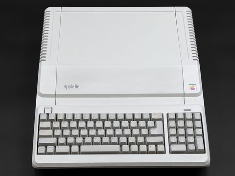 A light grey Apple IIe Platinum seen from directly above and front, with its built-in keyboard and numeric keypad, centered